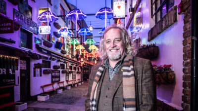 Michael Stewart, Belfast City Centre Night Czar stands in front of illuminated umbrellas